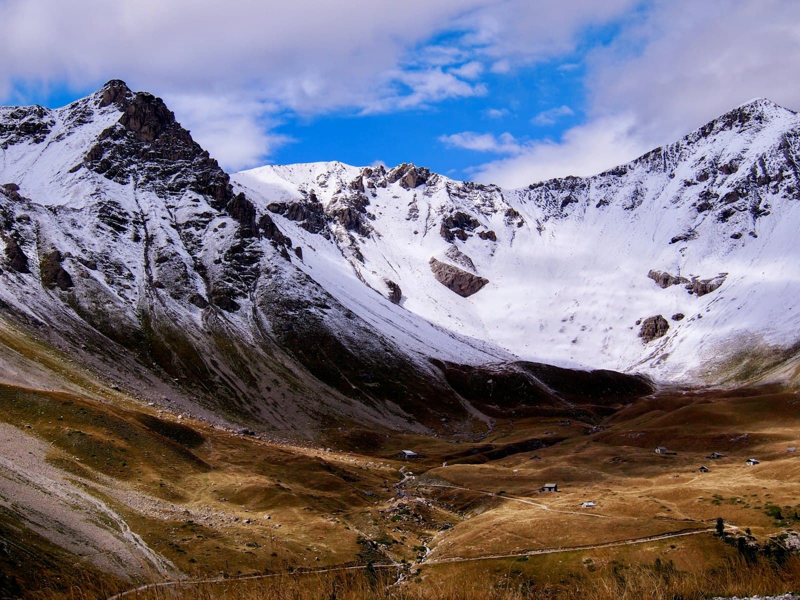 Briançon — a snow covered mountain with a wire fence in the foreground