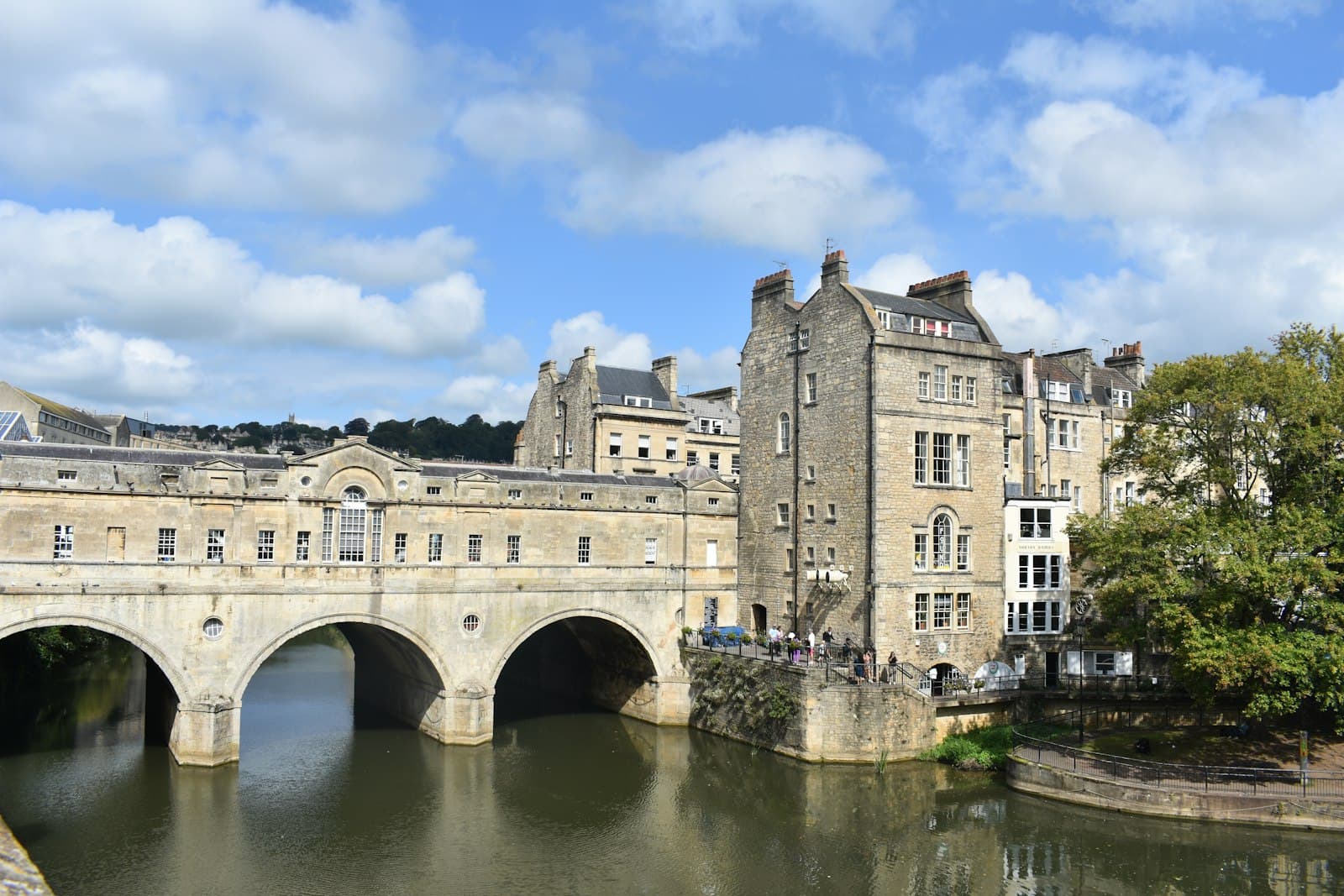 Bridgerton's Bath — a bridge over a body of water in front of a building