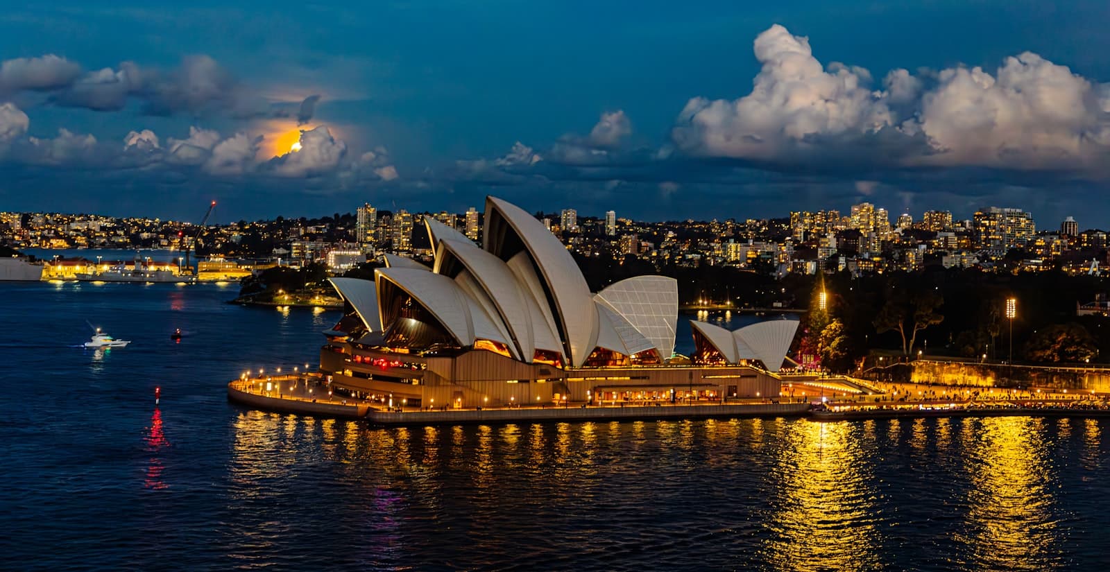 Bright — Sydney opera house illuminated at night with full moon