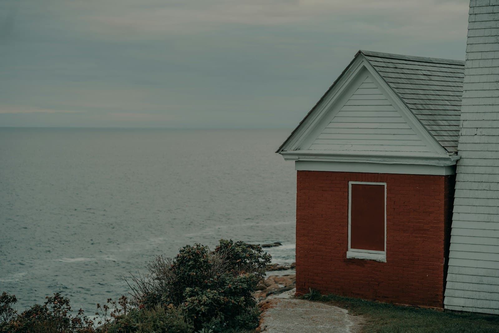 Bristol — a red building sitting on top of a cliff next to the ocean