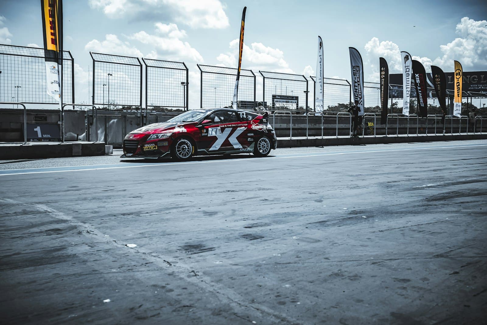 Buriram — Red and white rally car on race track.