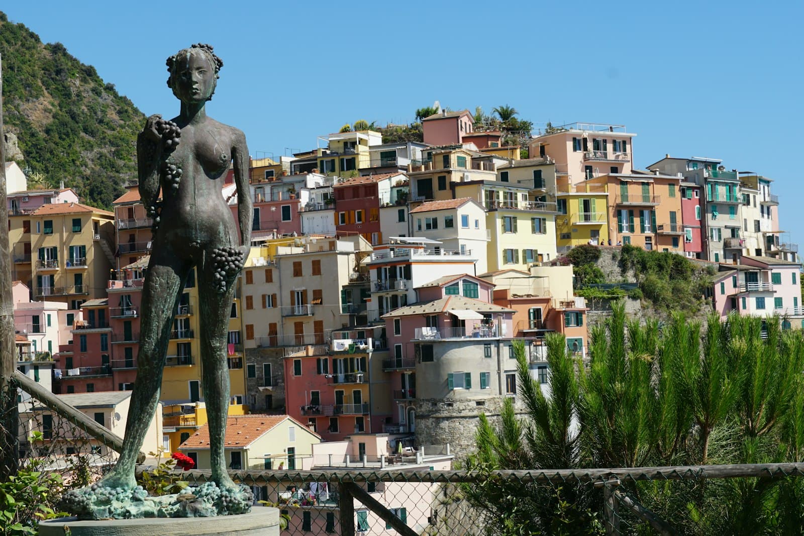 Busto Arsizio — A statue stands before colorful buildings