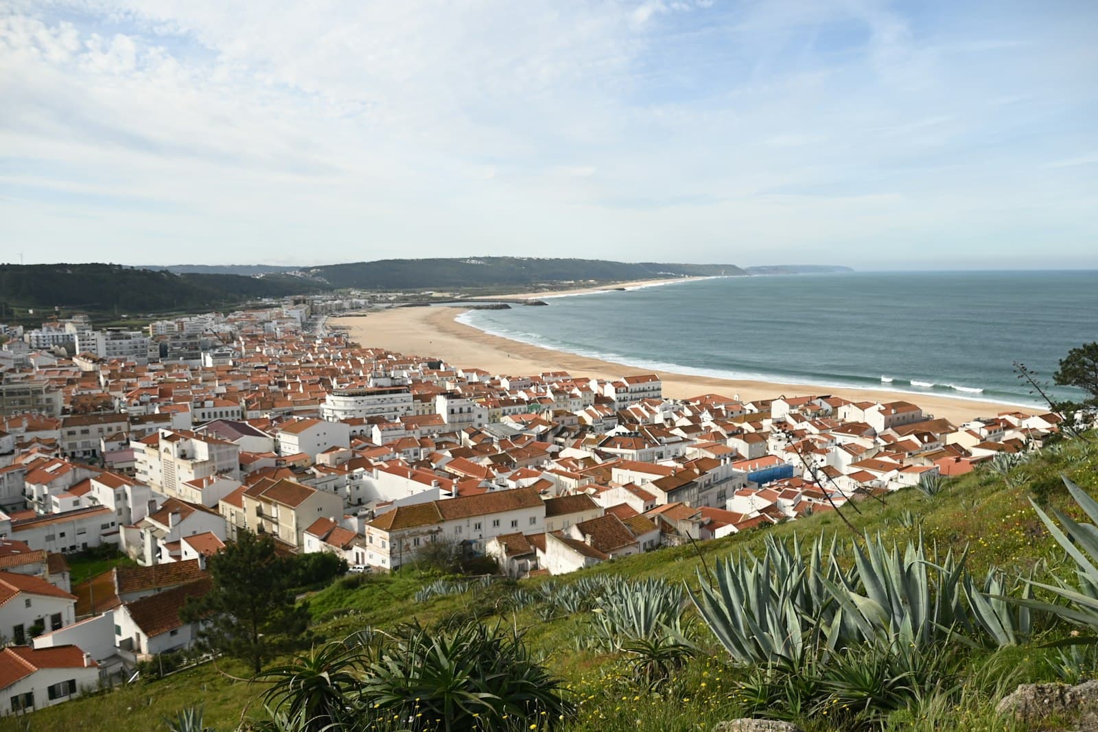 Cacela Velha — a view of a beach and a city from a hill