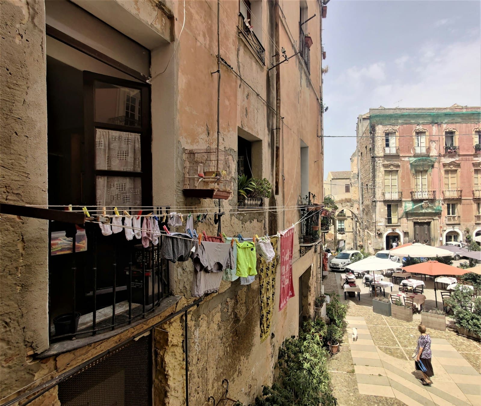 Cagliari — cars parked on sidewalk near buildings during daytime