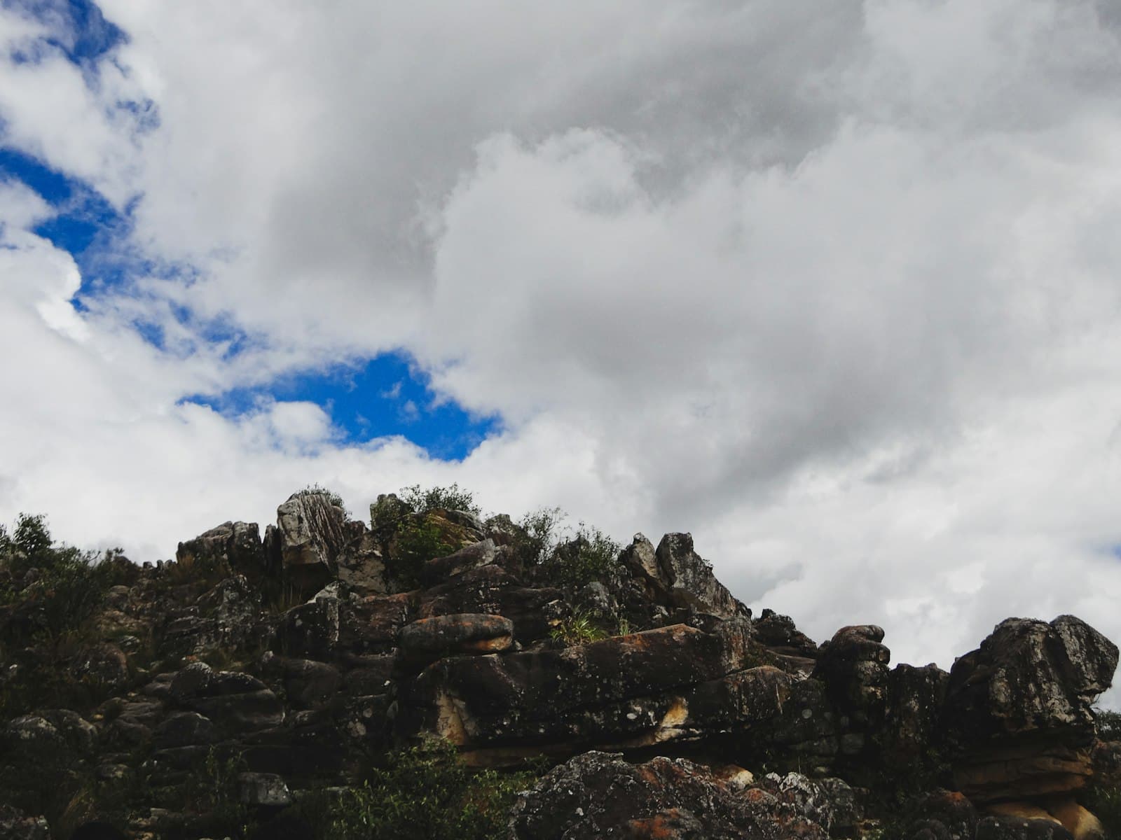 Cajamarca — a mountain with rocks and trees under a cloudy sky