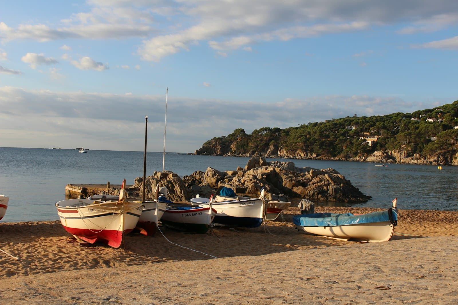 Calella de Palafrugell — a group of boats sitting on top of a sandy beach