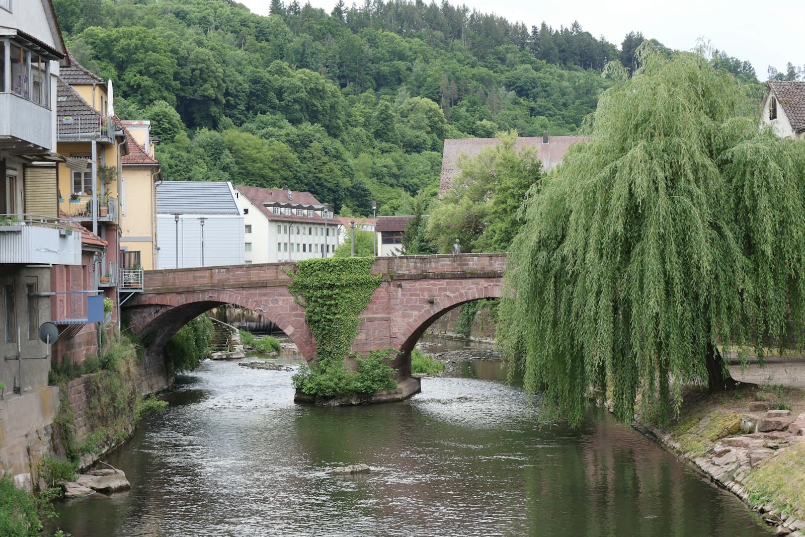 Calw — A river flows beneath a brick bridge.