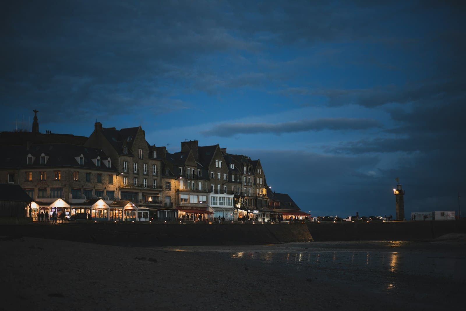 Cancale — a row of buildings on a beach at night