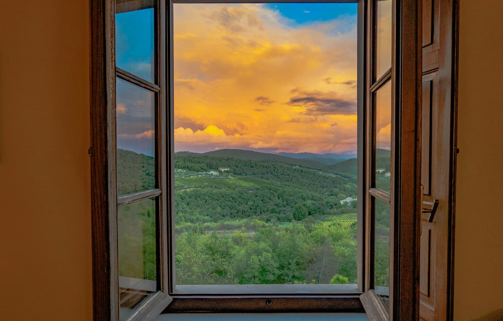 Castellina in Chianti — an open window with a view of the mountains