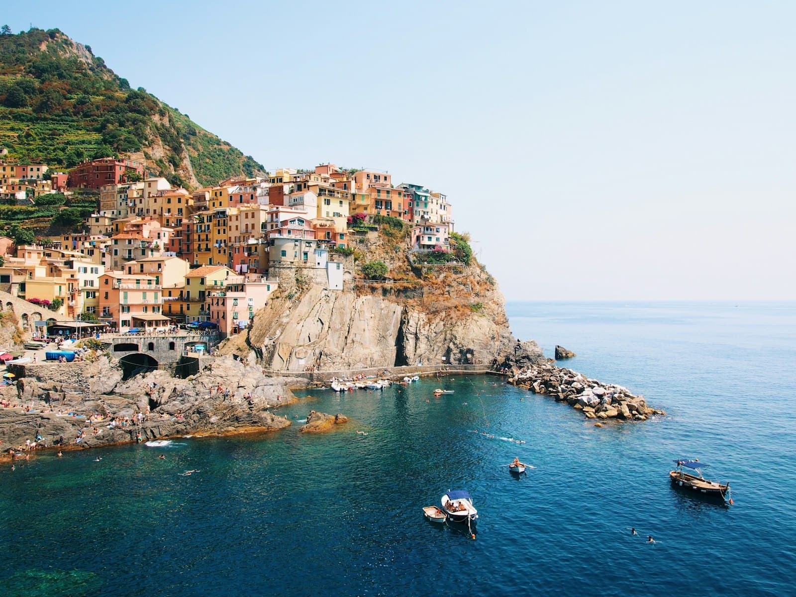 Castiglione della Pescaia — people riding on boat on sea near concrete buildings during daytime