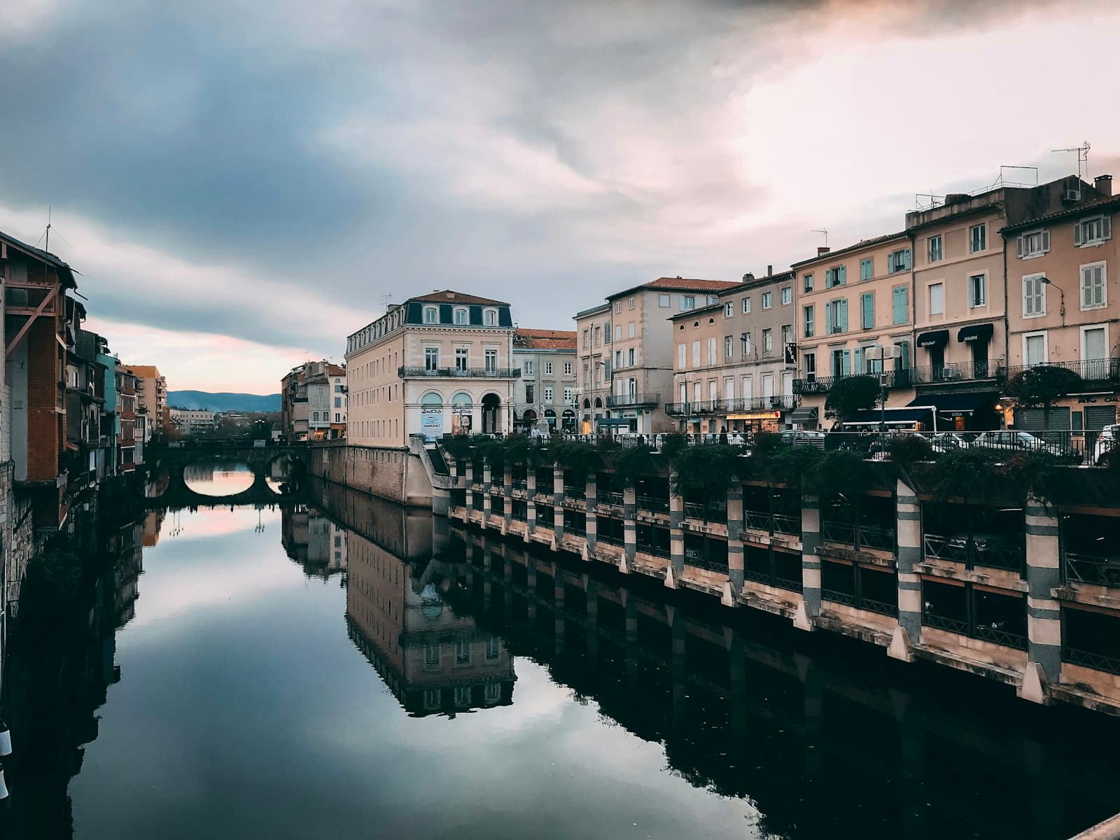 Castres — brown and white concrete building near body of water during daytime