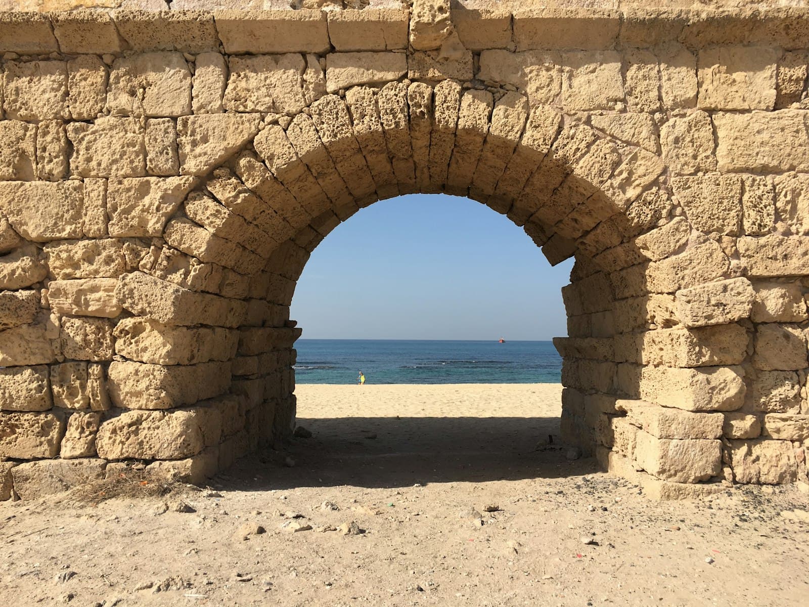 Caesarea — brown concrete arch near sea during daytime