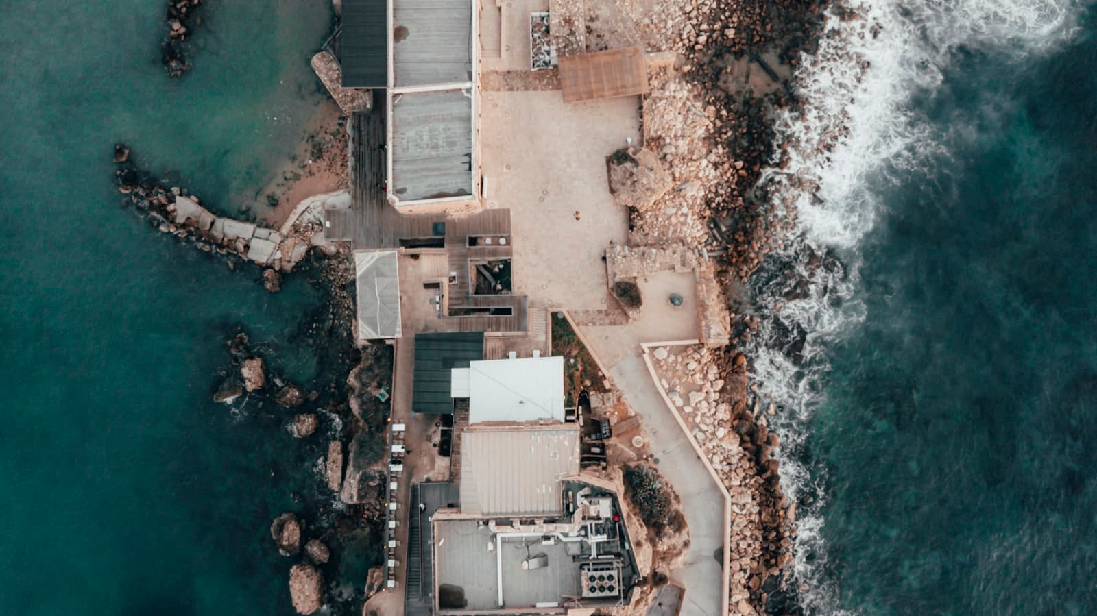Caesarea — aerial photography of buildings near body of water during daytime