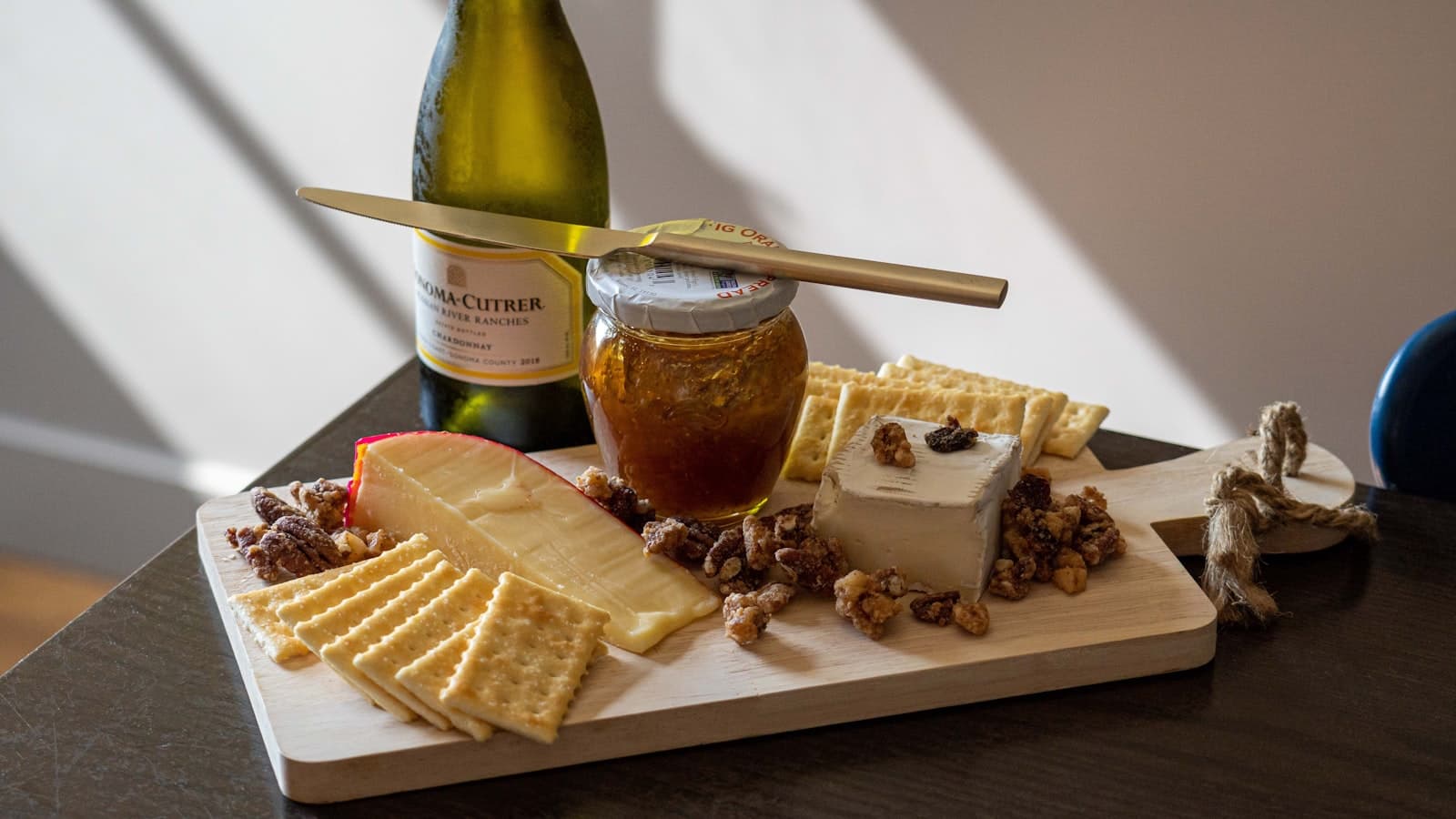 Champaign — a wooden cutting board topped with cheese and crackers