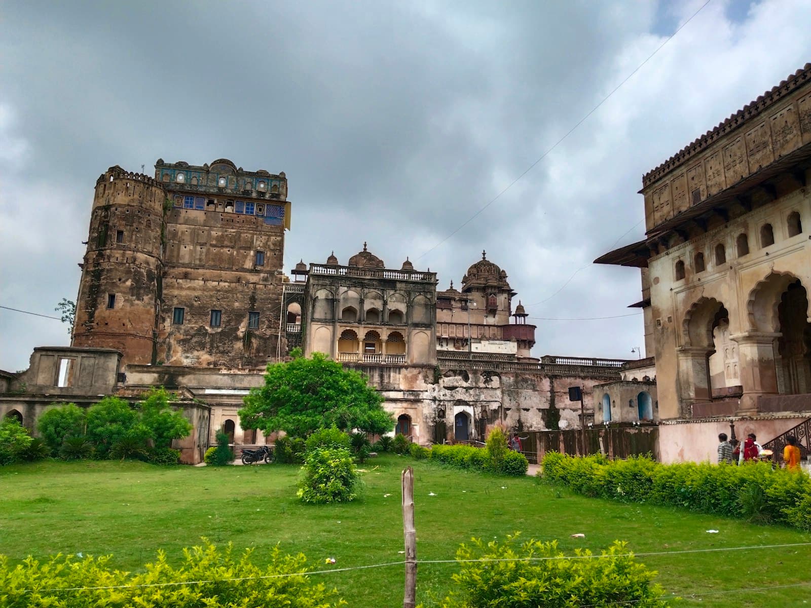 Chanderi — a large stone building with a green lawn in front of it