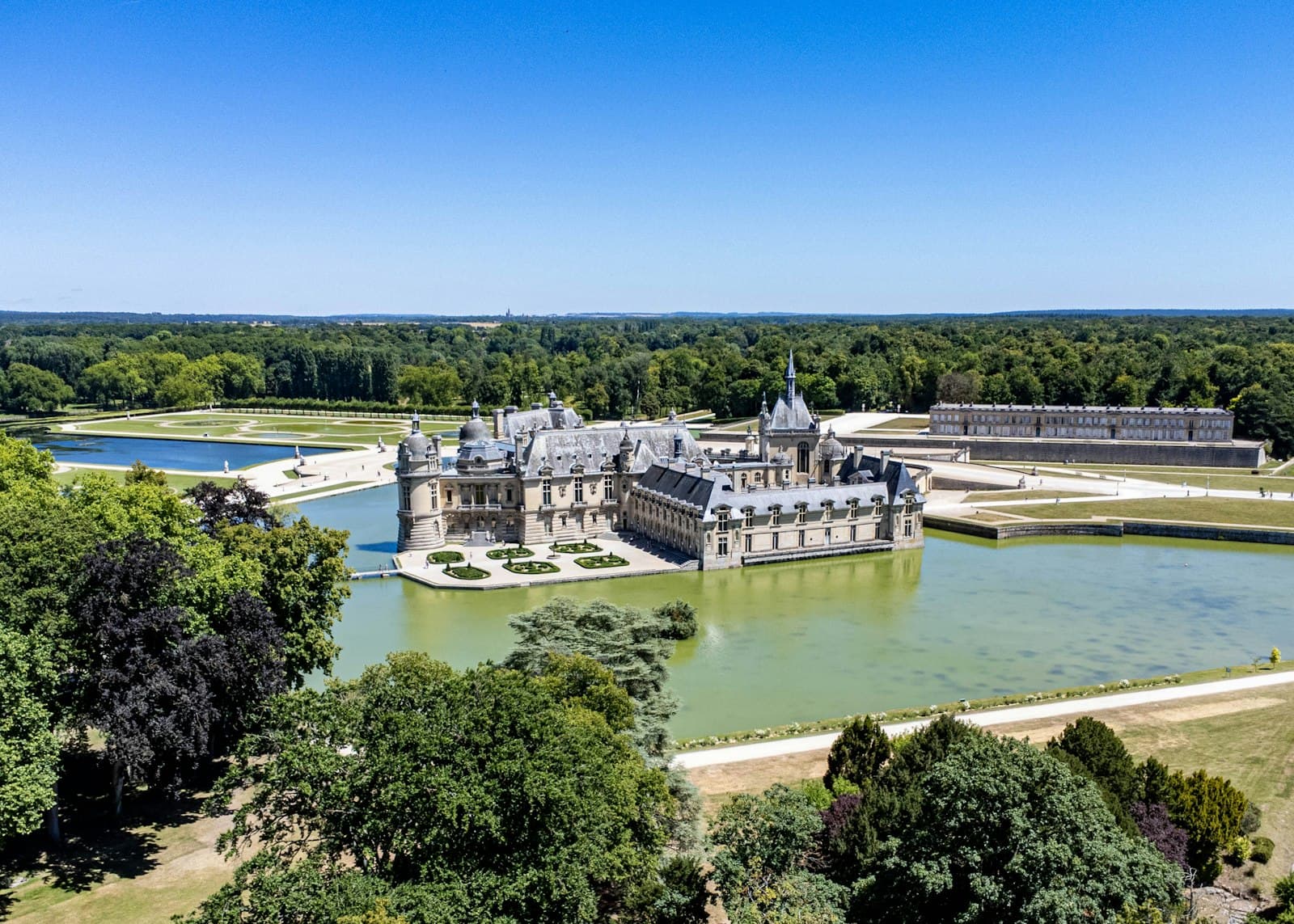 Chantilly — a castle on a hill by a river