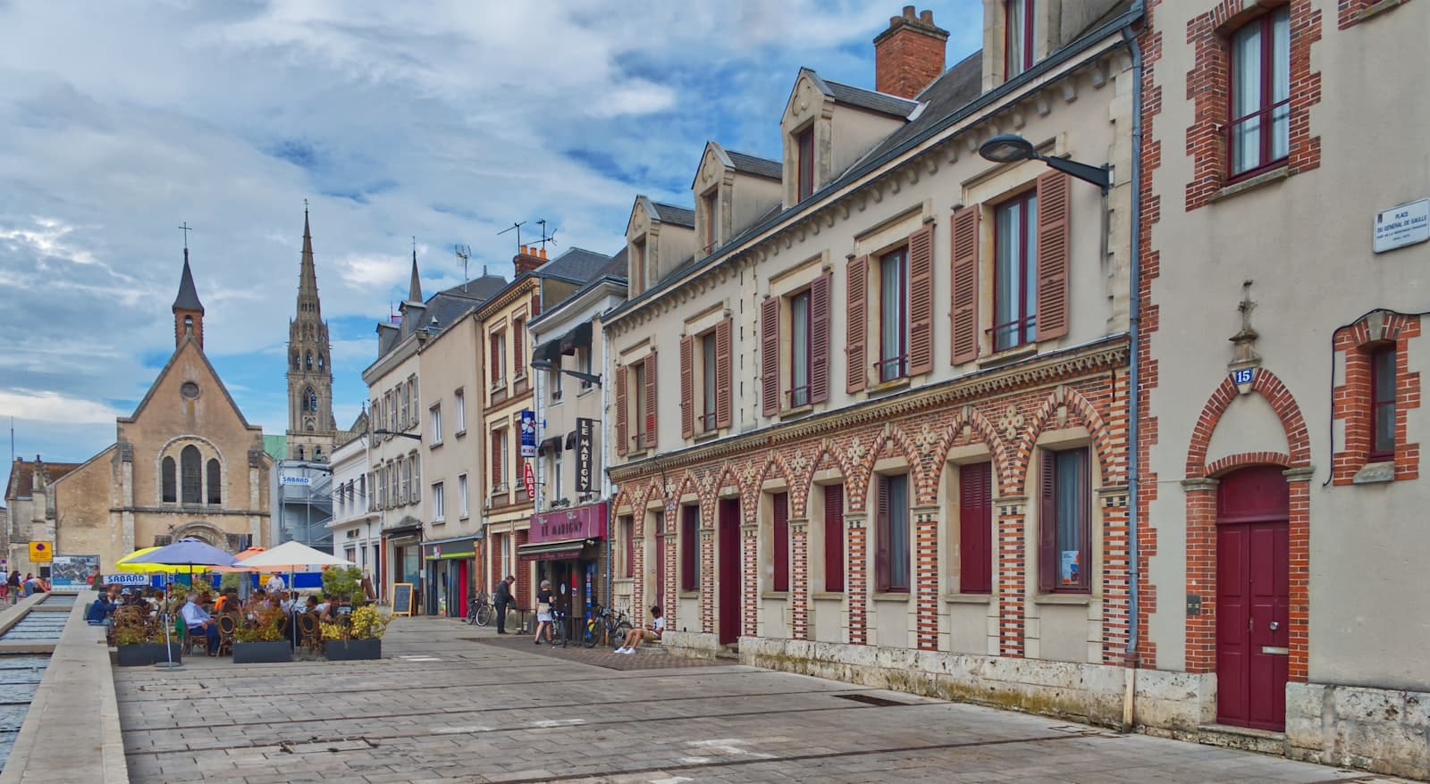 Chartres — a group of people walking down a street next to tall buildings