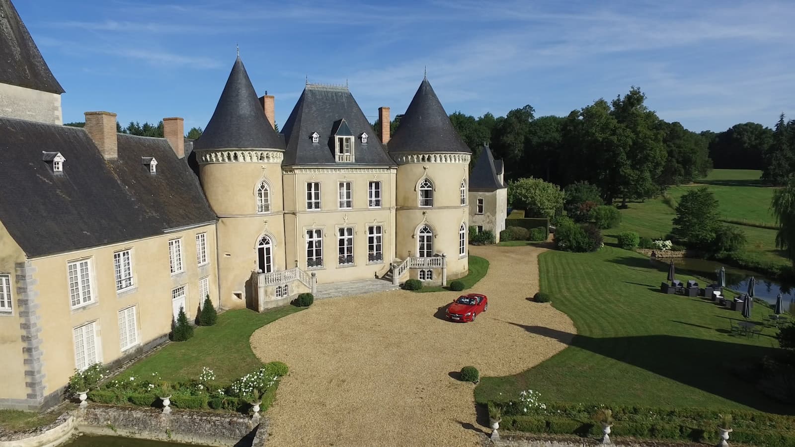 Château-Chinon — aerial view photography of red vehicle park in front of building