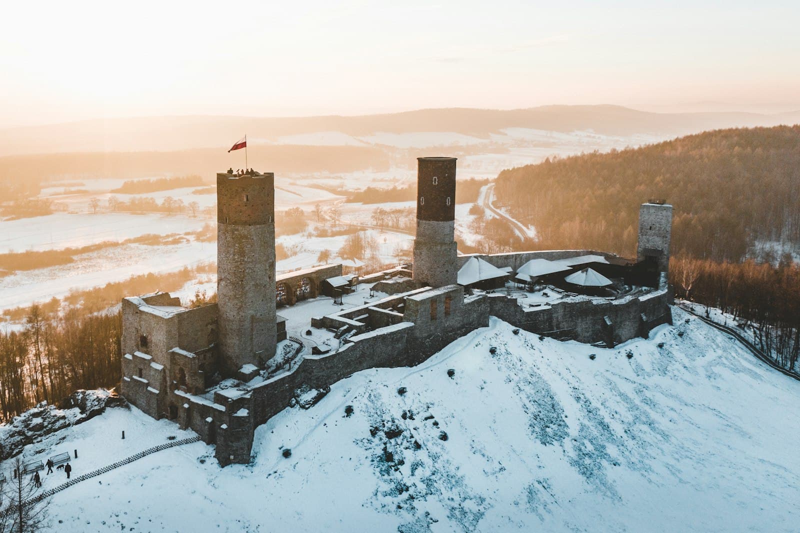 Chęciny — aerial view of gray concrete castle surrounded with snow