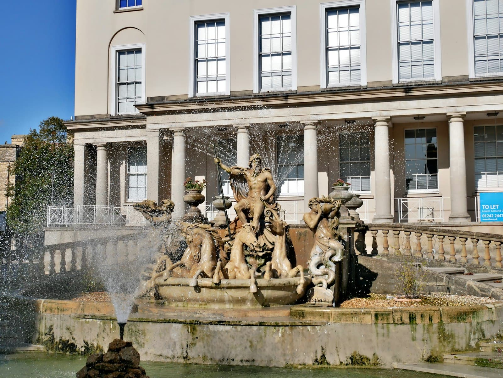 Cheltenham — a fountain in front of a large building