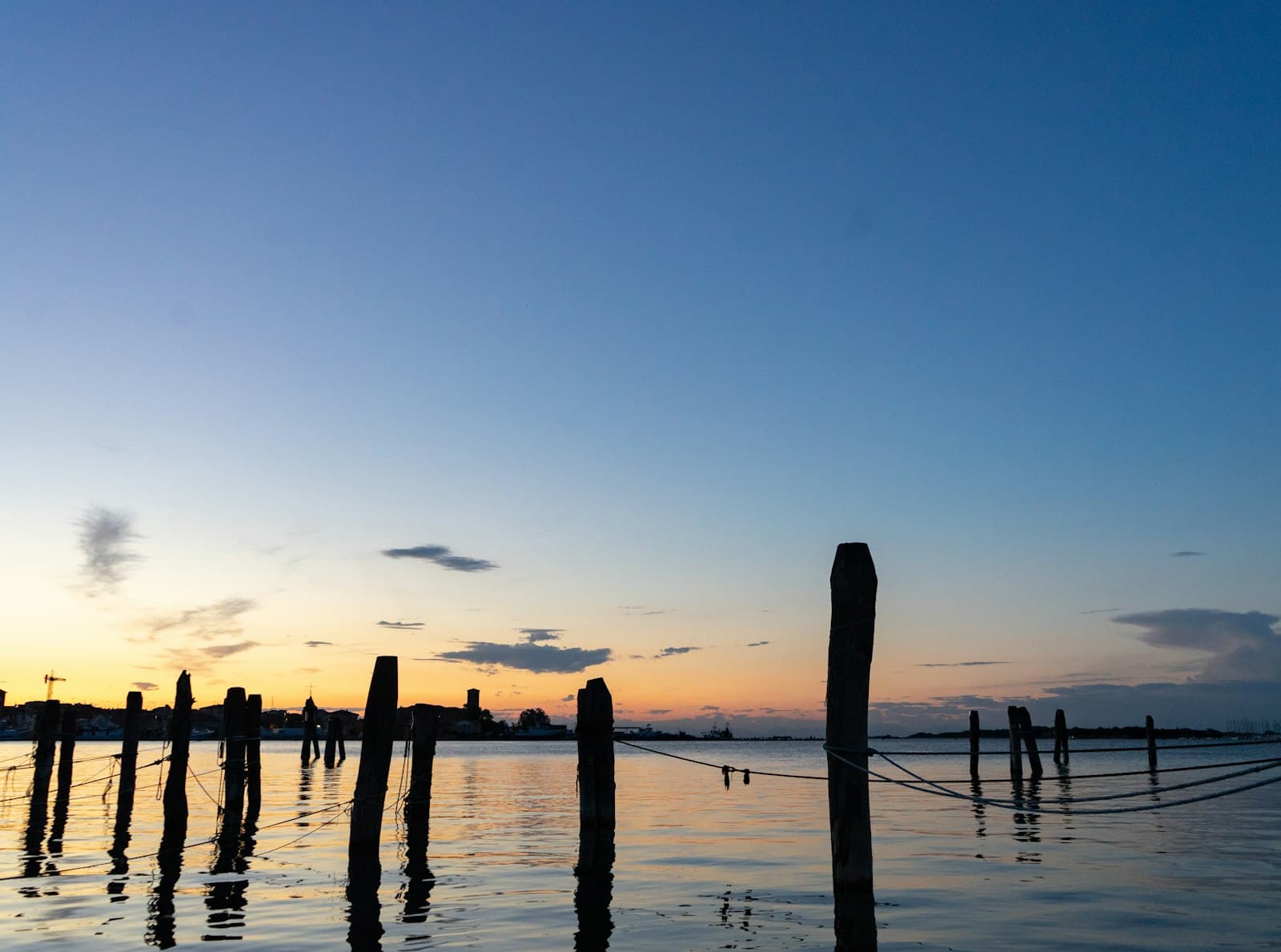 Chioggia — brown wooden post on sea during sunset