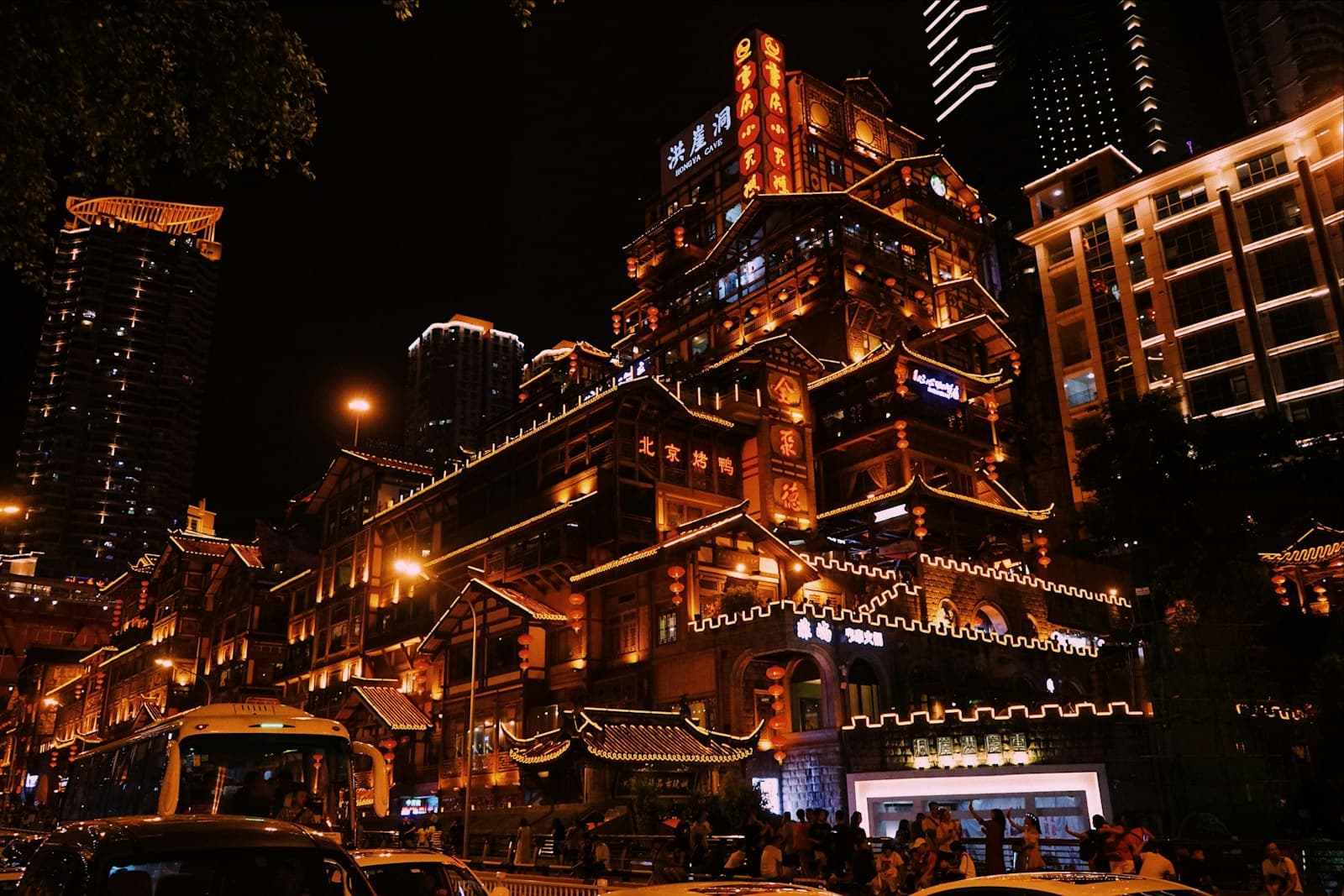 Chongqing — A city street at night with cars and buildings lit up