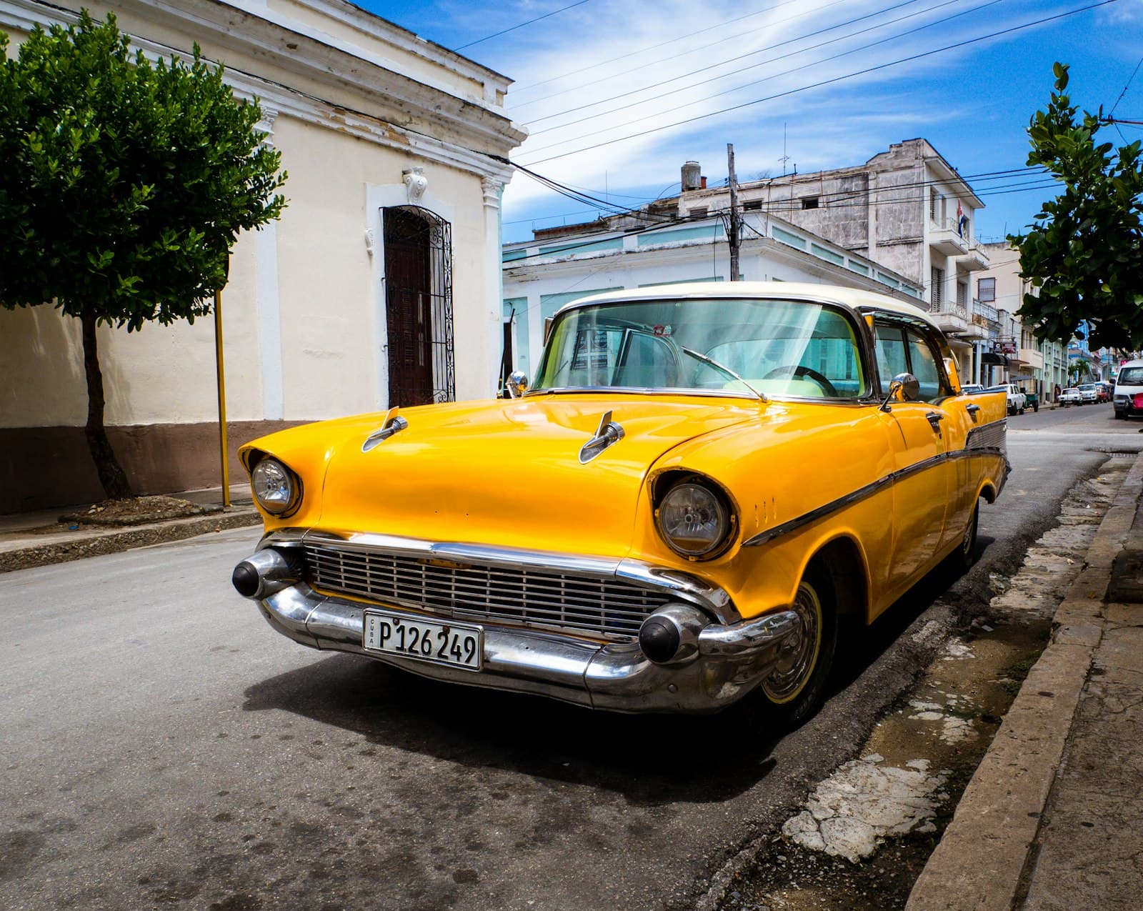 Cienfuegos — orange classic vehicle park on road