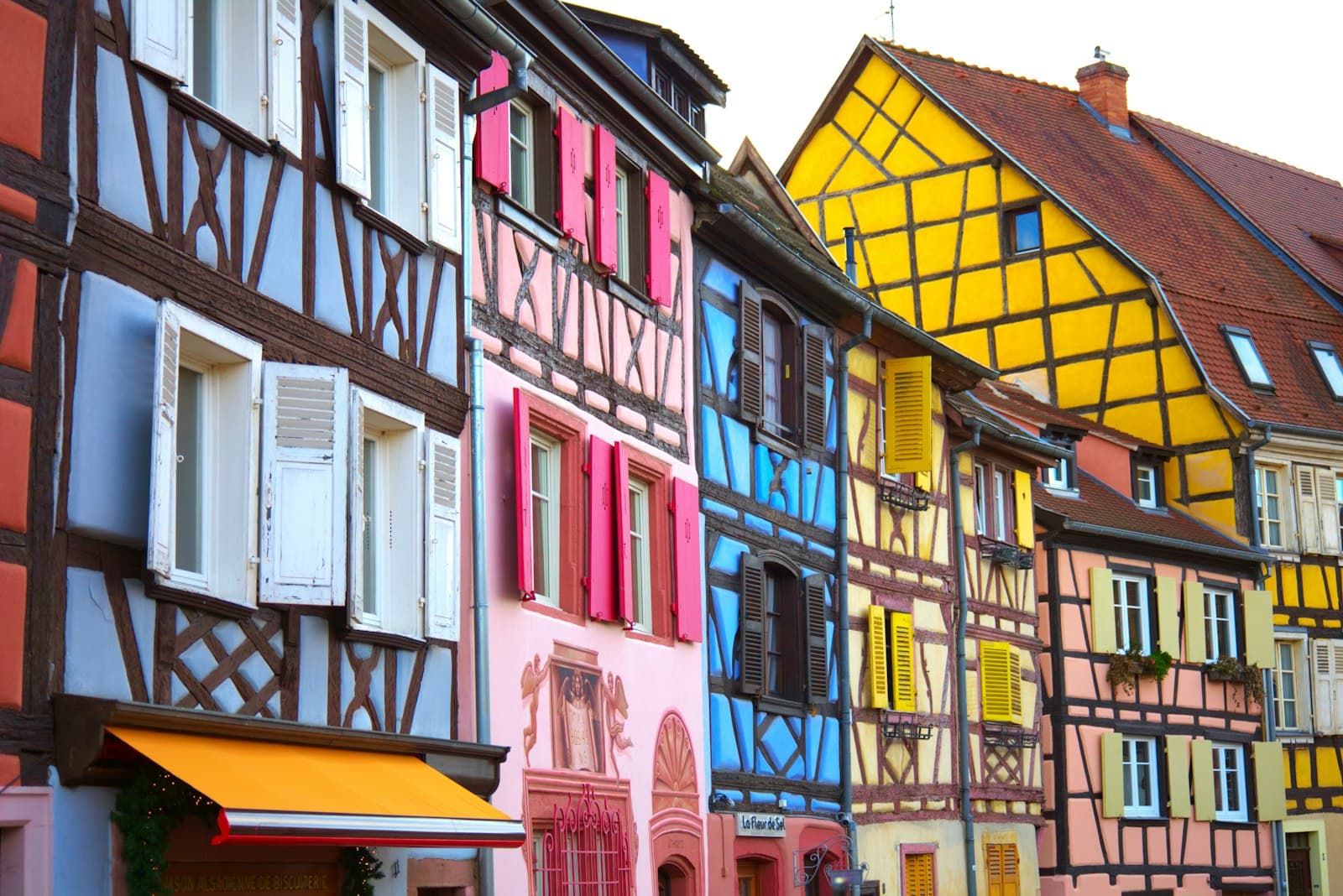 Colmar — a row of multicolored buildings with windows and shutters