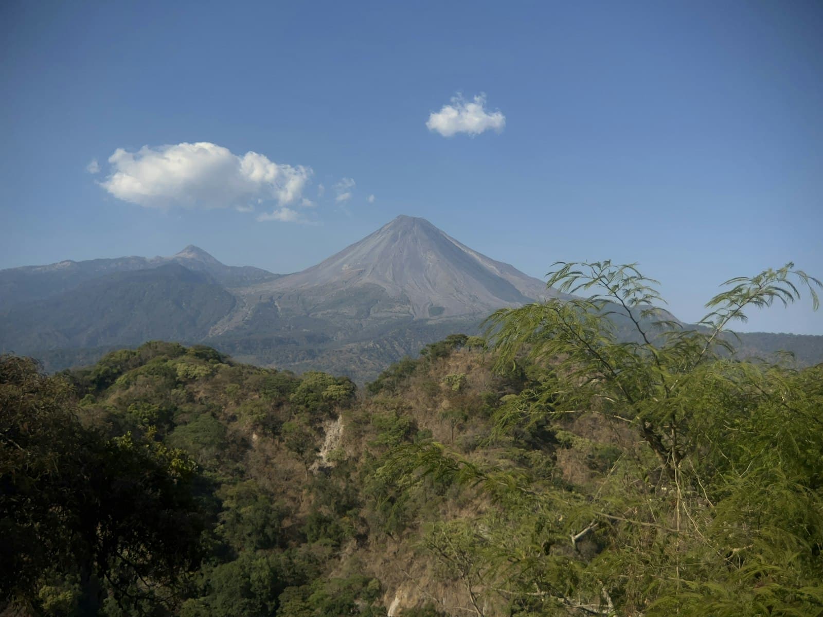 Comala — a mountain with trees and a blue sky