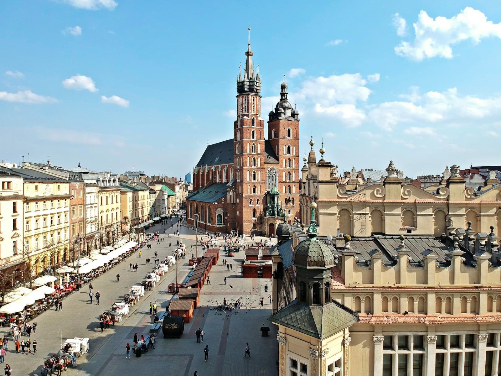 Krakow — a view of a city square with a clock tower in the background
