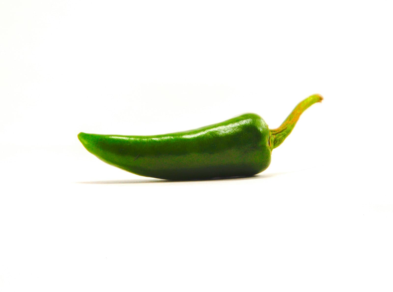 Cucao — green chili on white surface