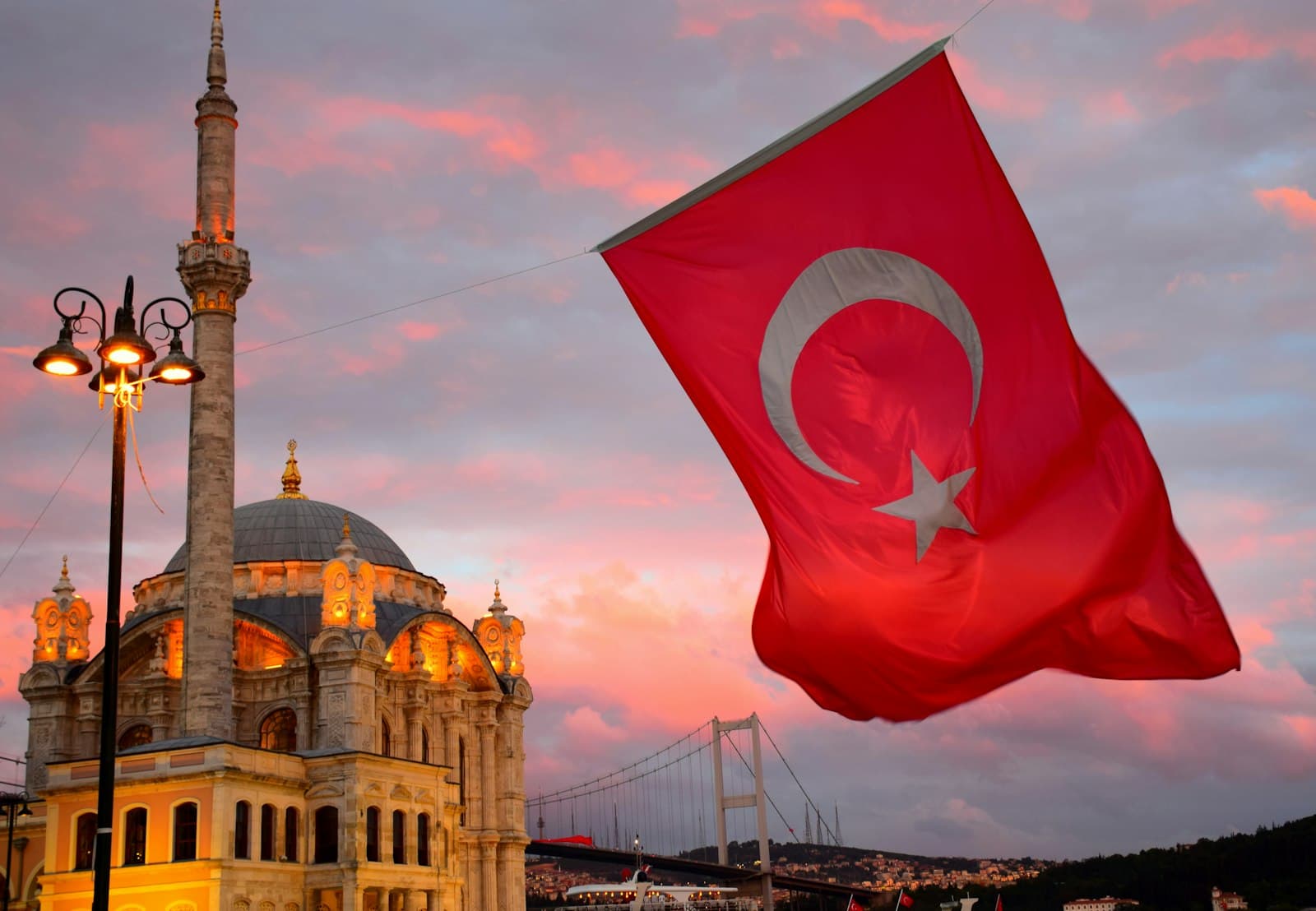 Cumalıkızık — red flag on top of brown concrete building during daytime