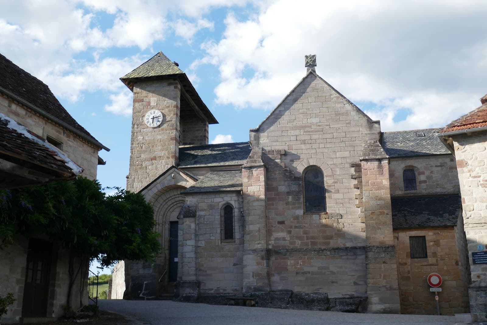 Curemonte — An old stone church stands in a quaint village.