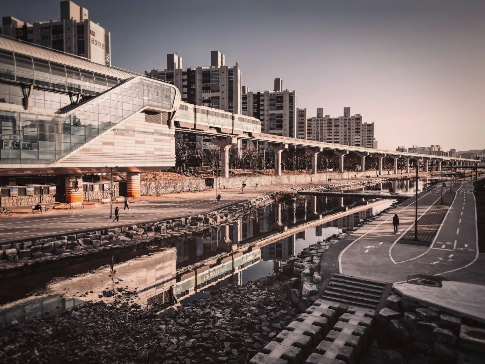 Daegu — An elevated train station sits beside a waterway.