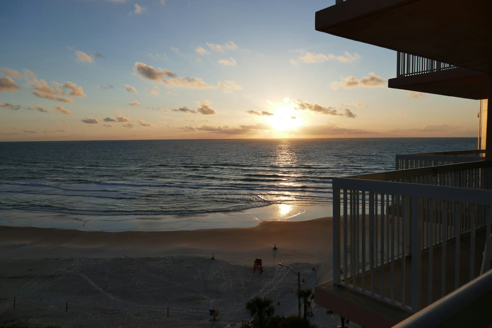 Daytona Beach — The sun is setting over the ocean from a balcony