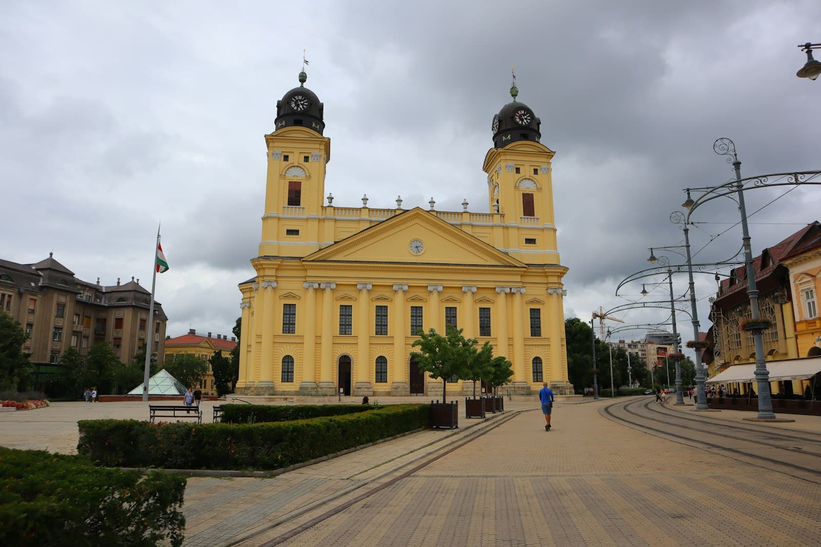 Debrecen — a large yellow building with two towers on top of it