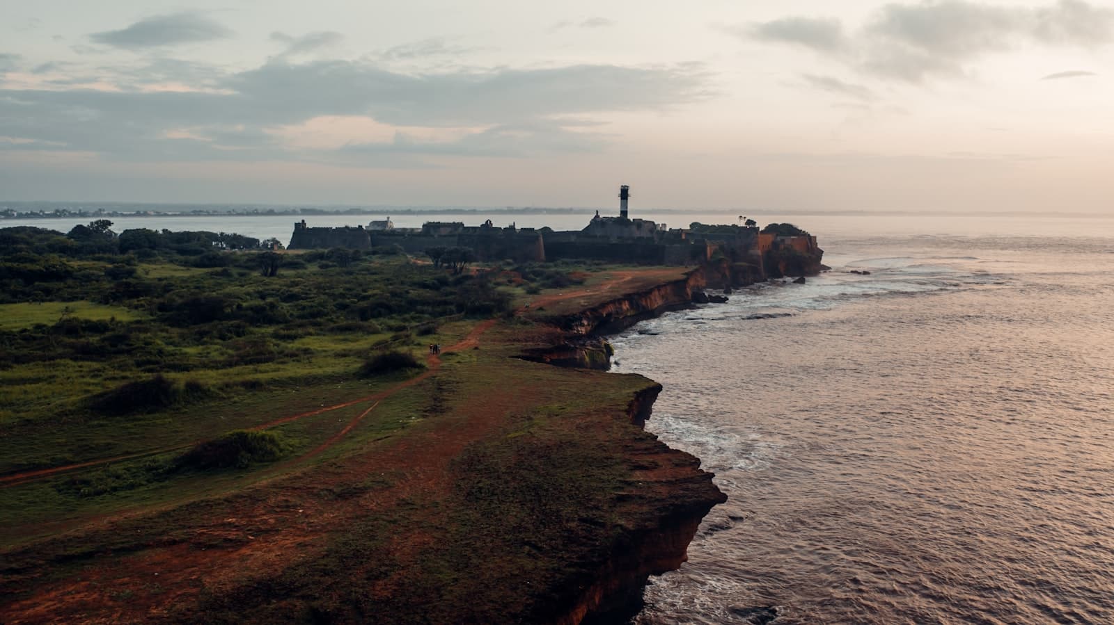 Diu — green grass field near body of water during daytime