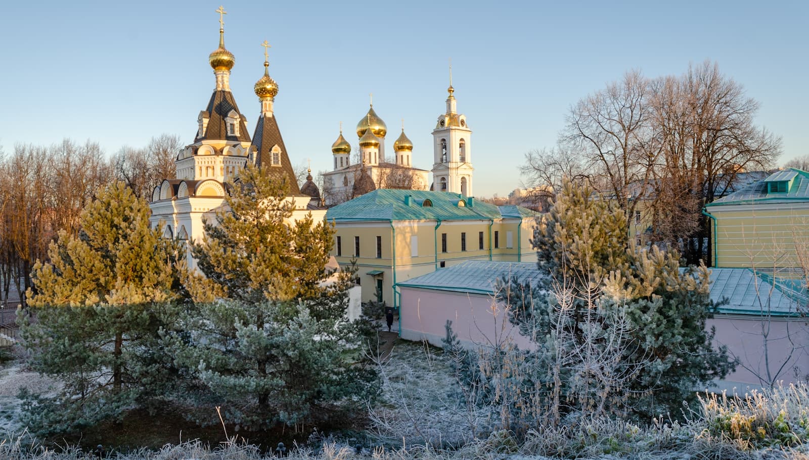 Dmitrov — a large building with a green roof surrounded by trees