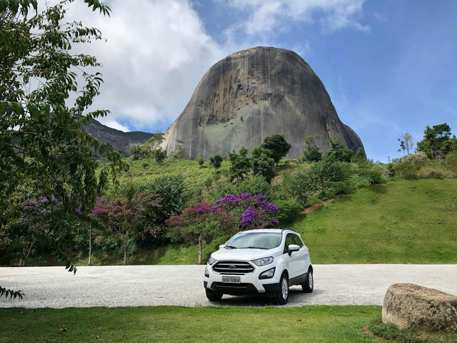 Domingos Martins — white suv parked near green grass and brown mountain during daytime