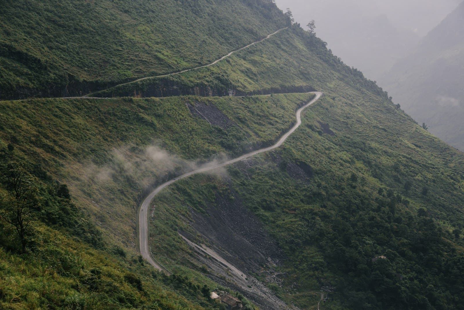 Đồng Văn — a winding road in the middle of a lush green hillside