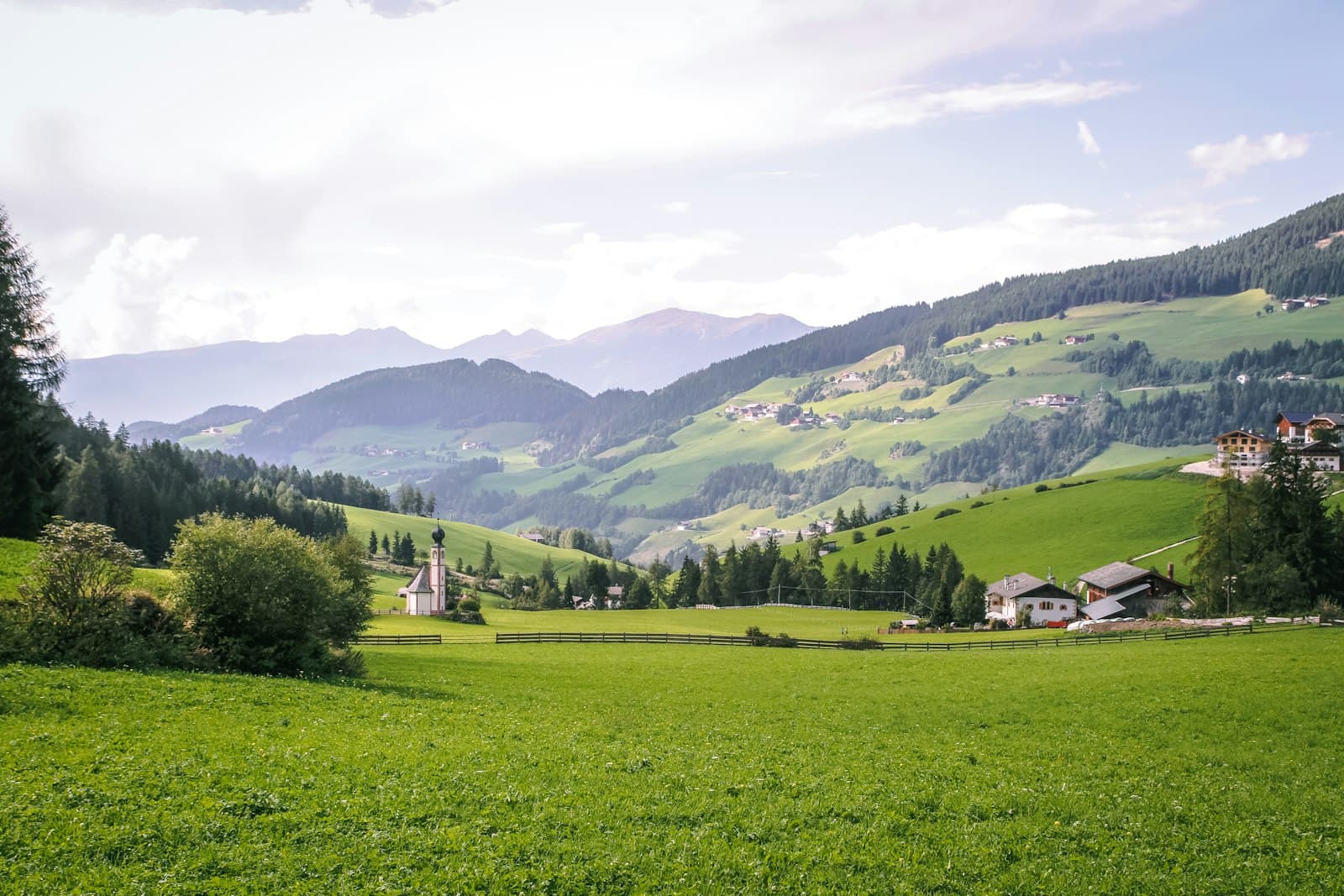 Dürnstein — green grass field near green mountains under white clouds during daytime
