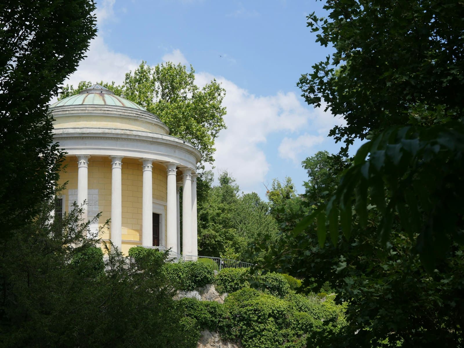 Eisenstadt — Yellow classical building with columns and dome surrounded by trees
