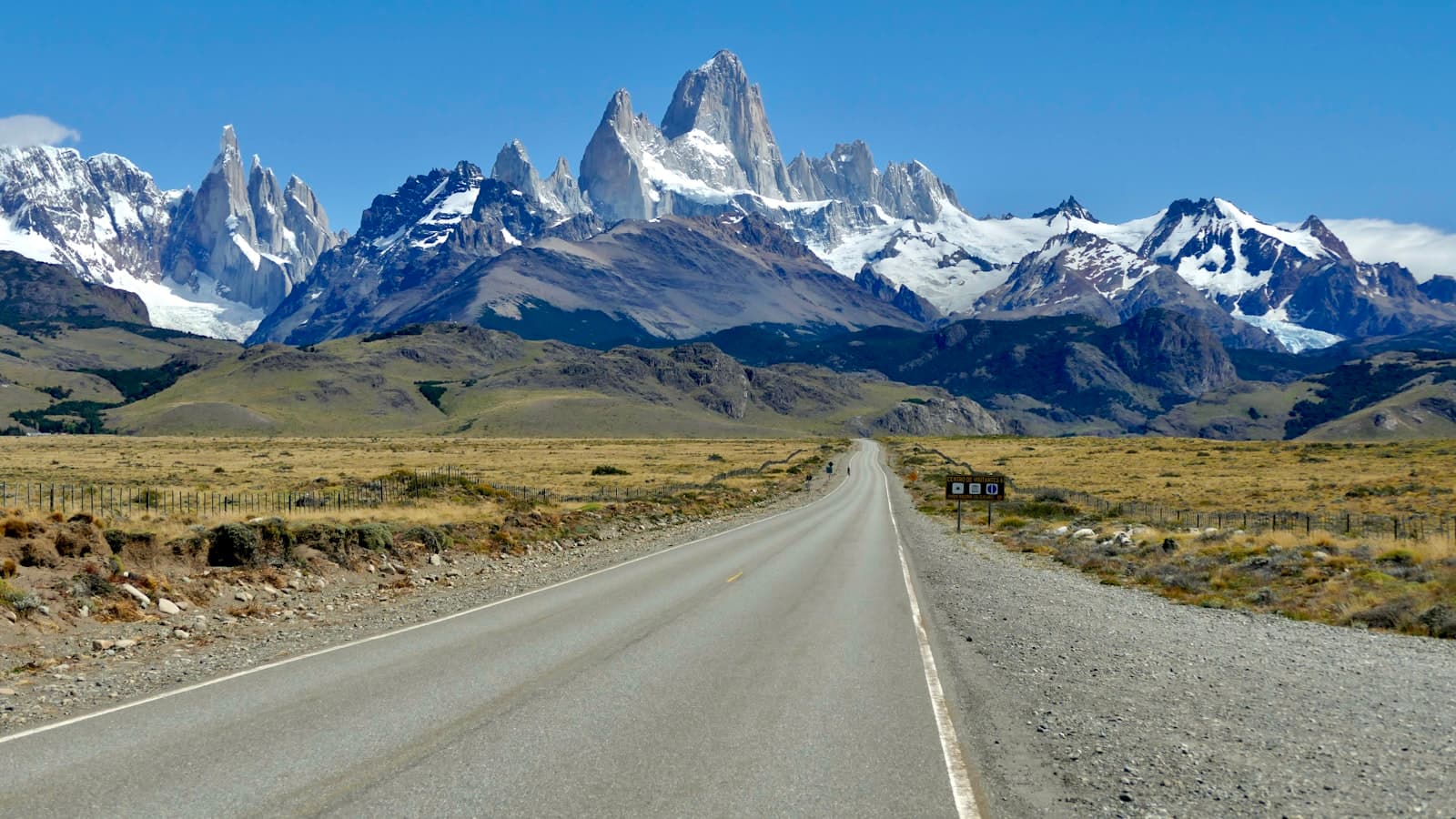 El Calafate — gray asphalt road near mountain range under blue sky during daytime