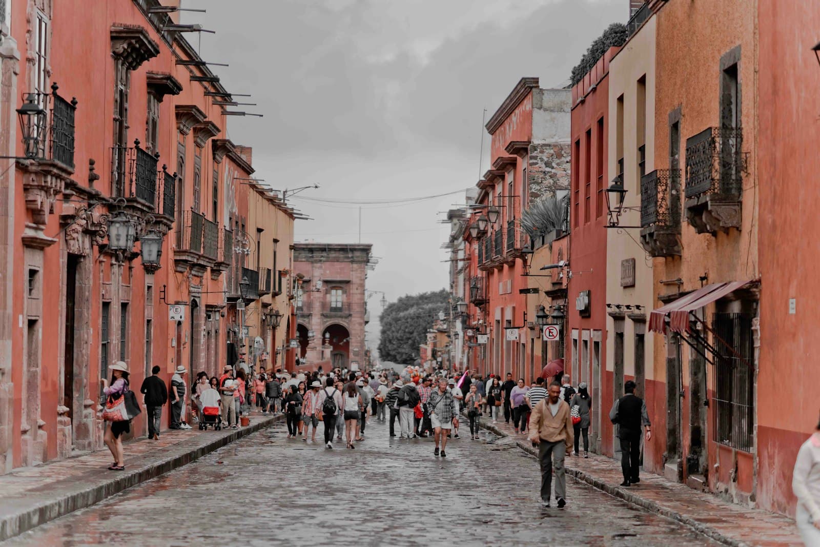 El Fuerte — people walking between orange concrete buildings