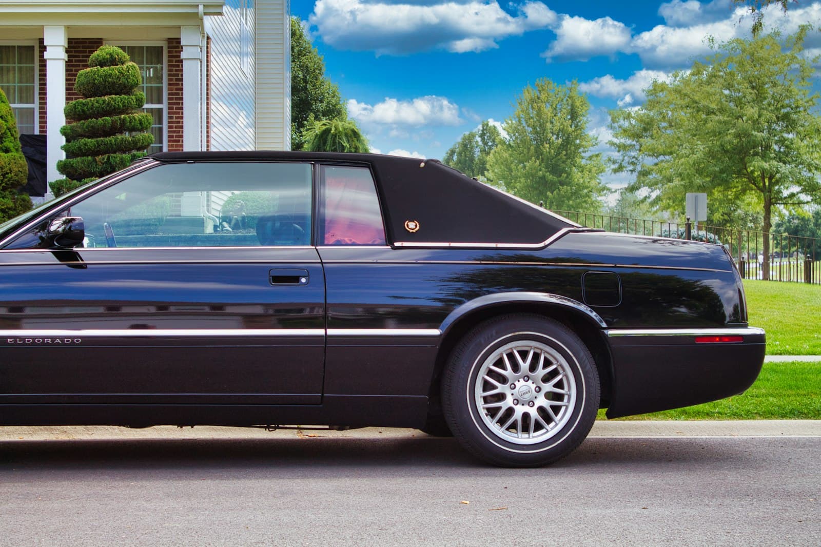 Elgin — a black sports car parked in front of a house