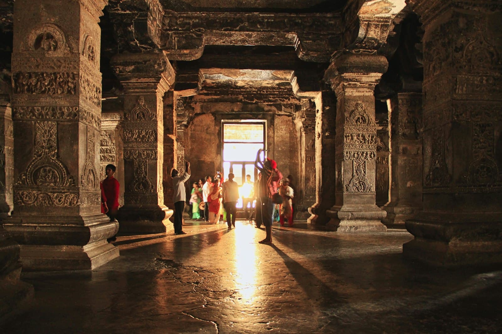 Ellora — people walking on hallway with red carpet