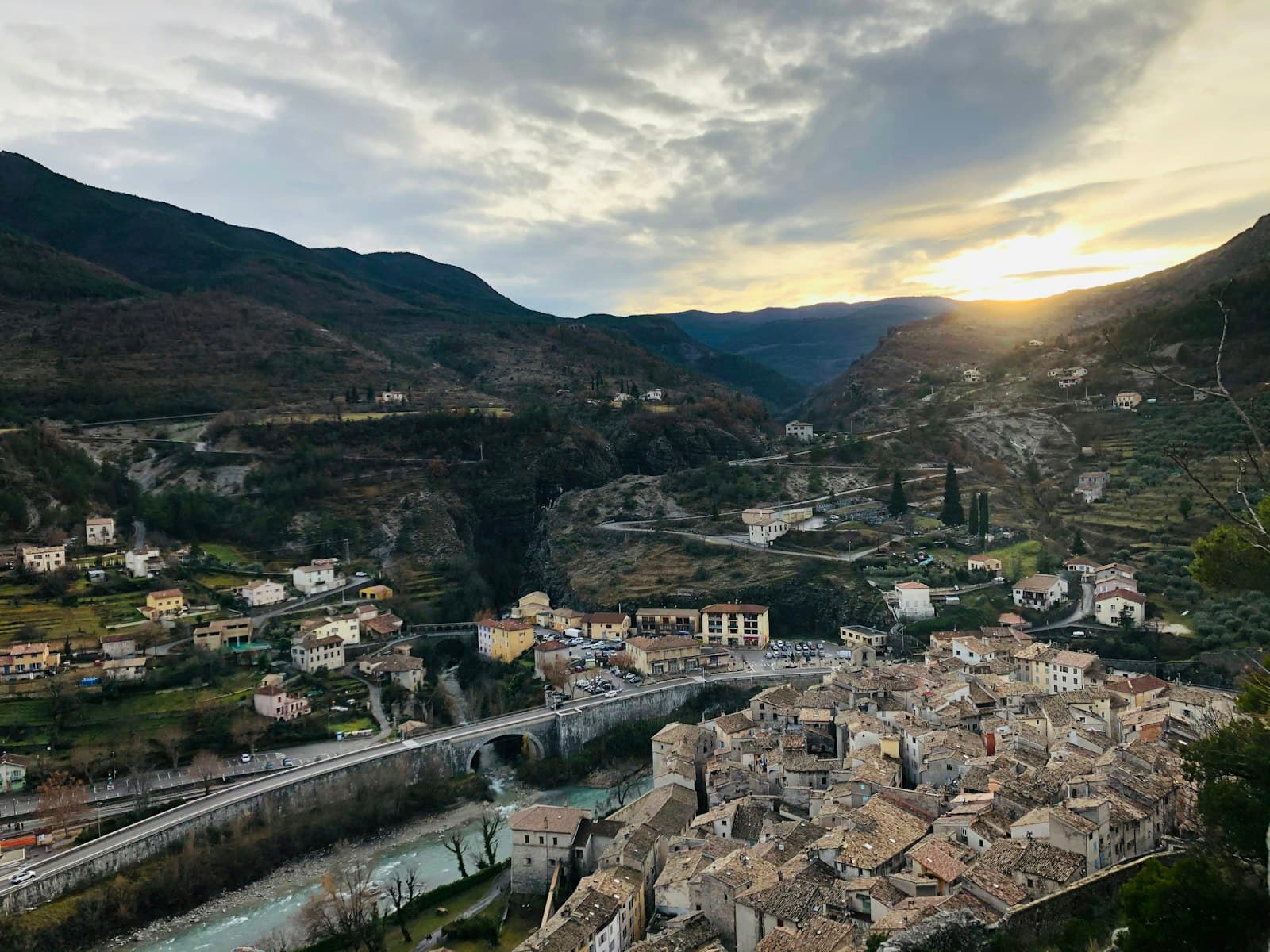 Entrevaux — city buildings near mountain under cloudy sky during daytime