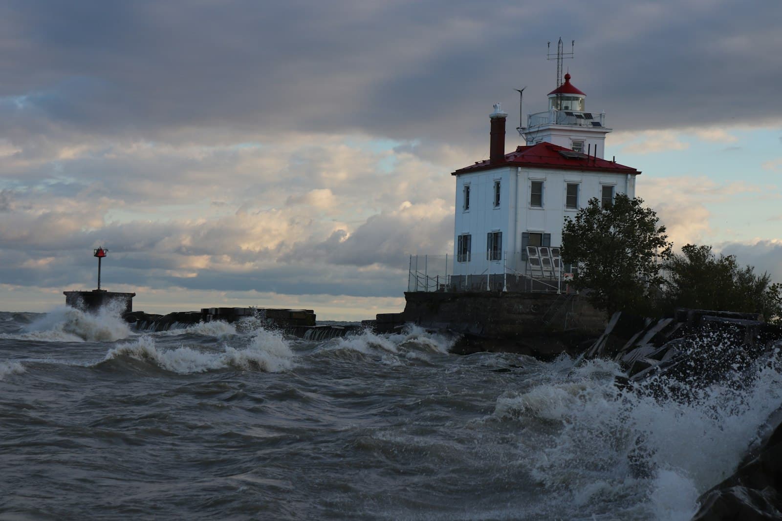 Erie — a light house sitting on top of a cliff next to the ocean