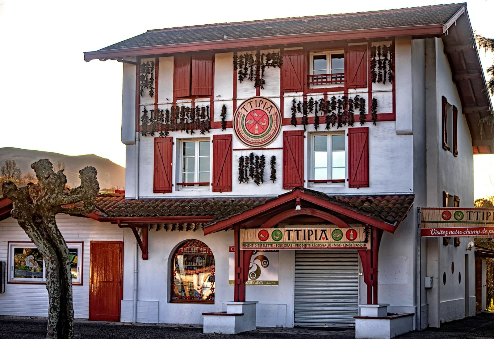Espelette — a white and red building with red shutters