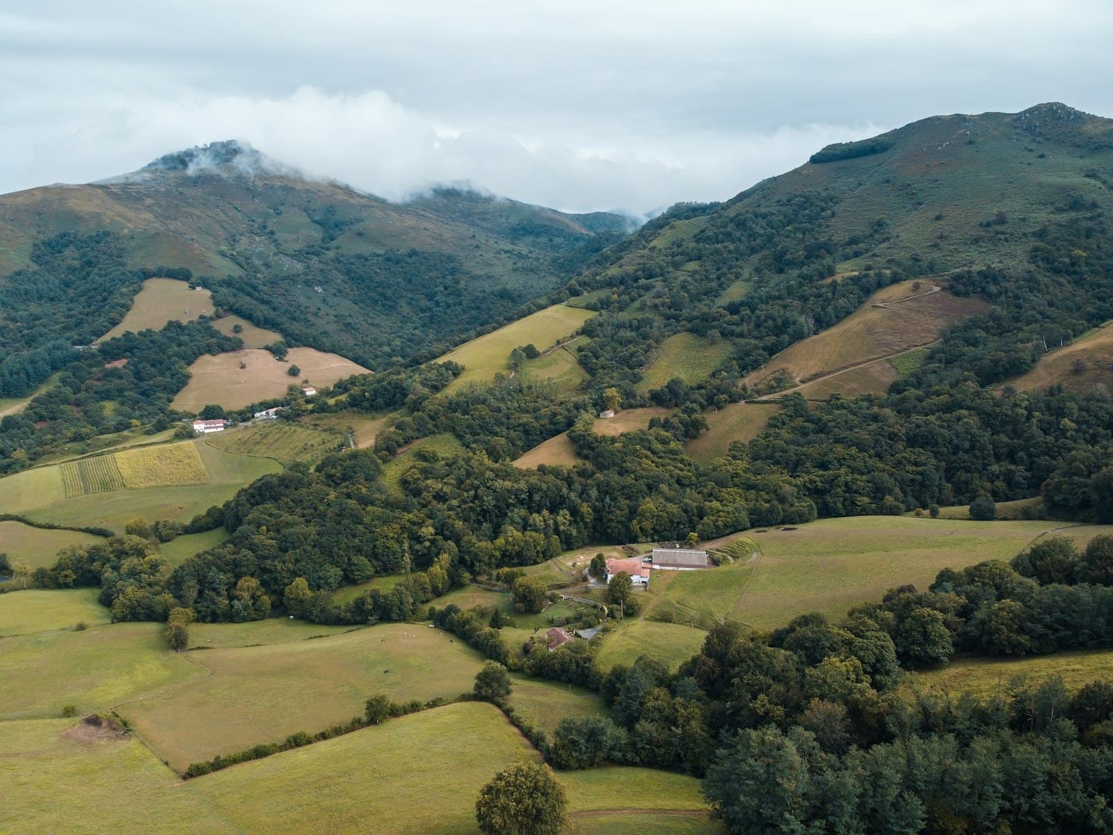 Espelette — green mountains under white sky during daytime